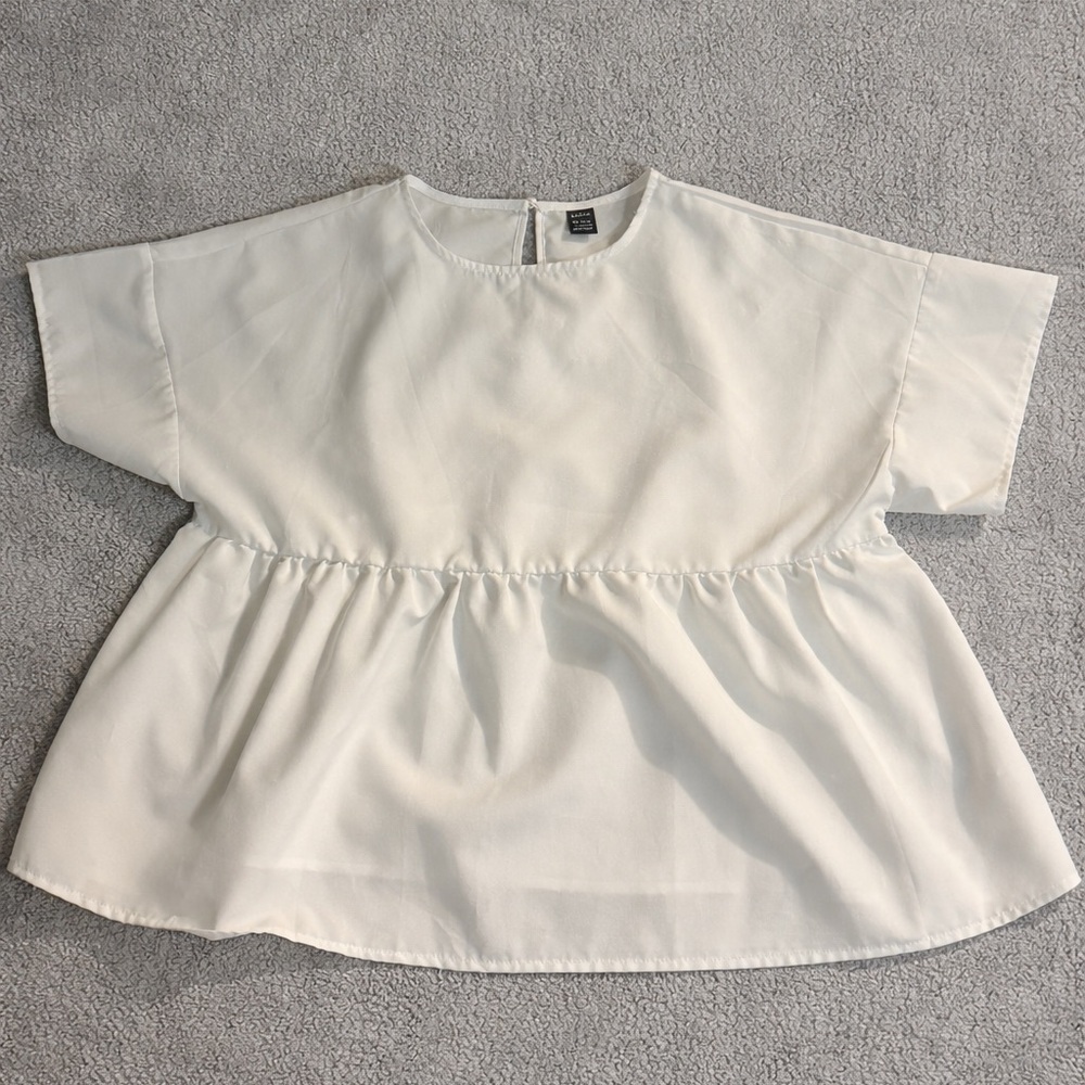 SHEIN Woman’s casual solid color batwing sleeve shirt.